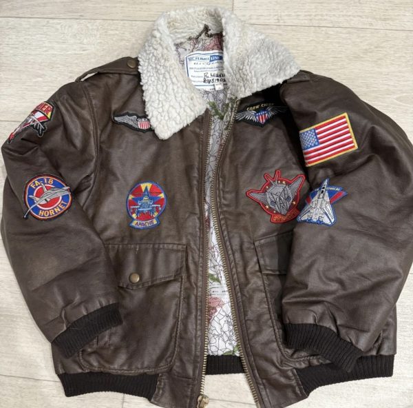 dumontthrift Brown and cream vintage flight bomber jacket jacket distressed leather, embroidered patches, vintage aviator, bomber style, military-inspired, cream accents, quilted lining, casual outerwear, rugged texture, retro aesthetic